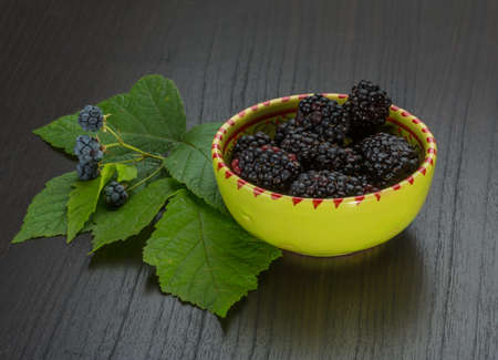 Blackberry with leaves in the bowlの写真素材