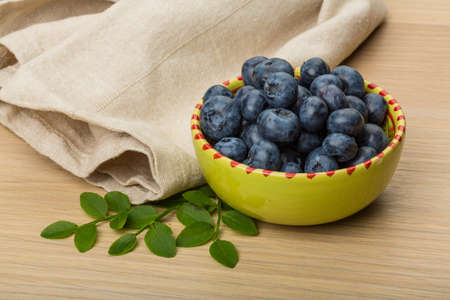Blueberry with leaves in the bowlの写真素材