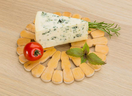 Blue cheese with rosemary and mint on the desk