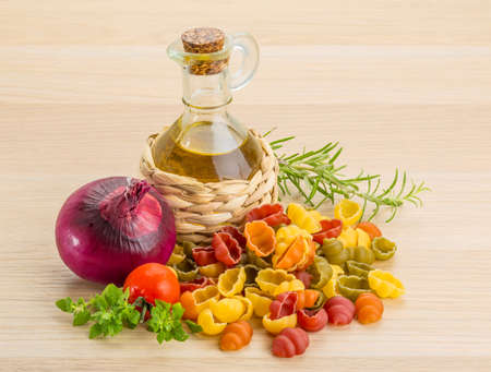 Raw macaroni - shell pasta with herbsの写真素材