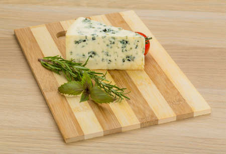 Blue cheese with rosemary and mint on the deskの写真素材