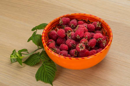 Raspberry in the bowl with leavesの写真素材
