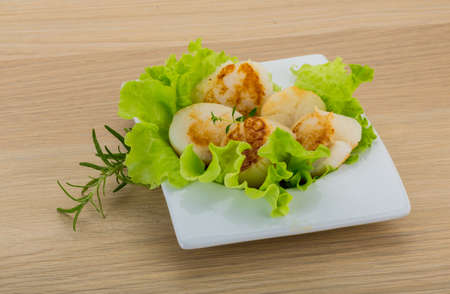 Grilled scallops with herbs on the boardの写真素材