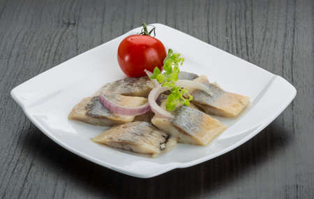Sliced herring with oregano on the plate