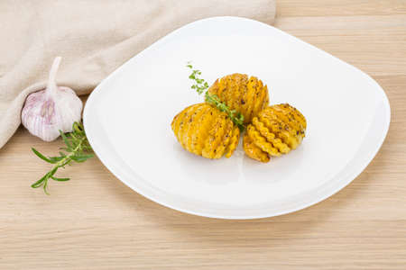 Baked tomato with rosemary and oregano on the desk