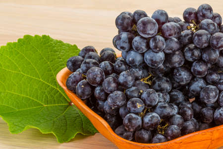 Red grape branch with leafの写真素材