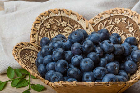 Blueberry with leaves in the bowlの写真素材