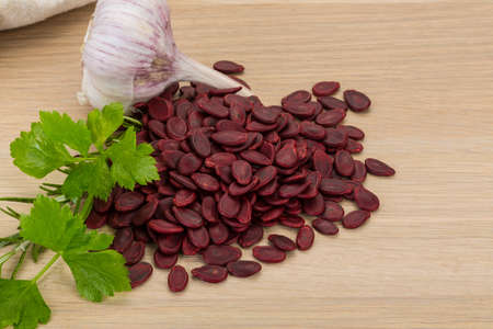 Red pumpkin seeds on the desk