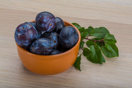 Fresh bright plums in the bowlの写真素材