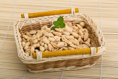 Peanut in the bowl on wood background