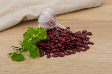 Red pumpkin seeds on the desk