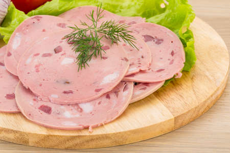 Beef sausage sliced with salad and garlikの写真素材