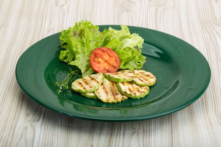 Grilled zucchini in the bowl with salad leavesの写真素材