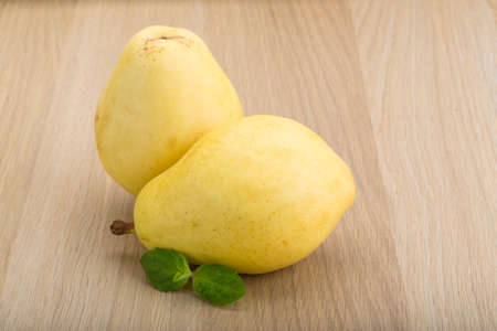 Bright ripe Yellow pears with mint leavesの写真素材
