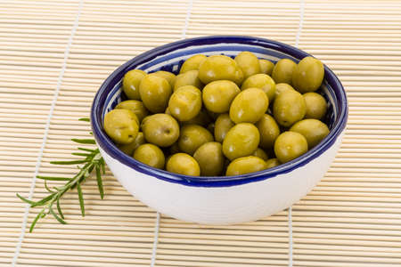 Green olives marinated - in the bowlの写真素材