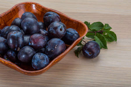 Fresh bright plums in the bowlの写真素材
