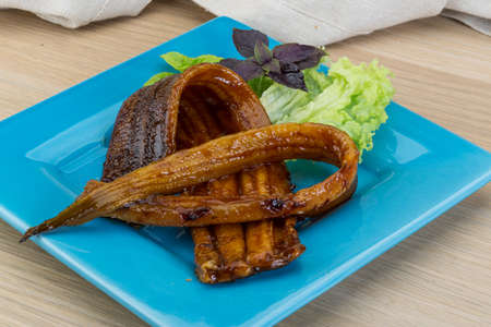 Smoked eel with salad leaves and basilの写真素材