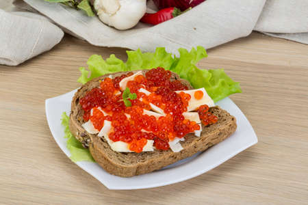 Sandwich with red caviar, butter and salad leavesの写真素材