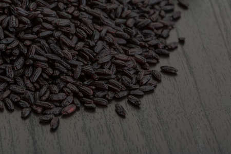 Raw black rice on the boardの写真素材