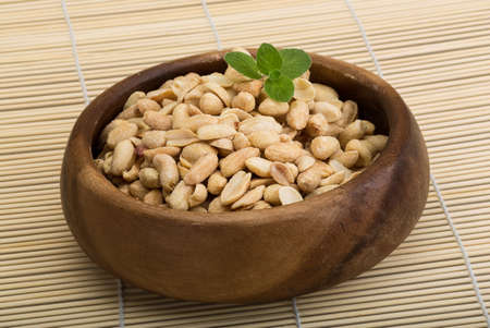 Peanut in the bowl on wood background