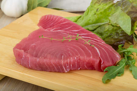 Raw tuna steak with rosemary and thymeの写真素材