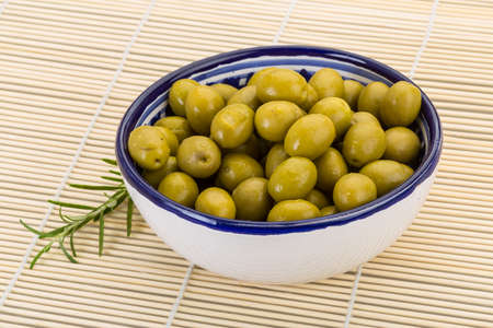 Green olives marinated - in the bowlの写真素材