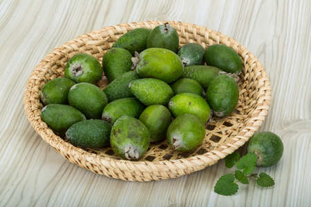 Feijoa in the bowl on wooden backgroundの写真素材