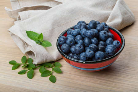 Blueberry with leaves in the bowlの写真素材