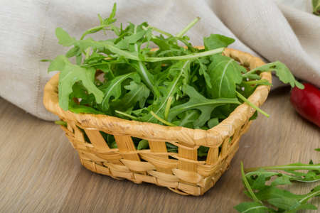 Ruccola leaves mix in the bowl on wooden の写真素材