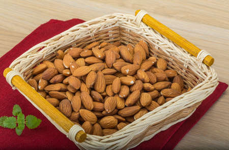 Almond in the bowl on wooden backgroundの写真素材