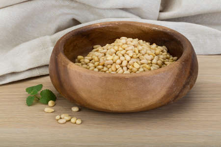 Cedar nut in the bowl on wooden backgroundの写真素材