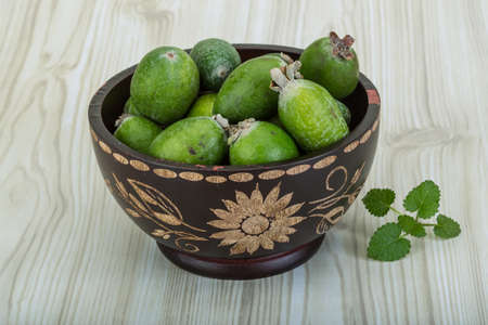 Feijoa in the bowl on wooden backgroundの写真素材