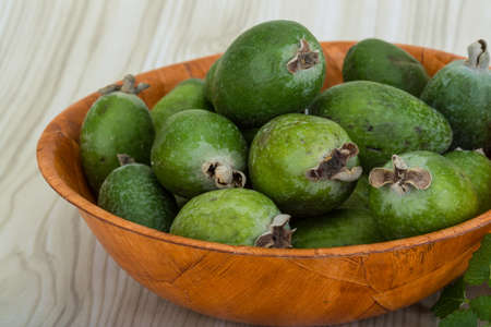 Feijoa in the bowl on wooden backgroundの写真素材