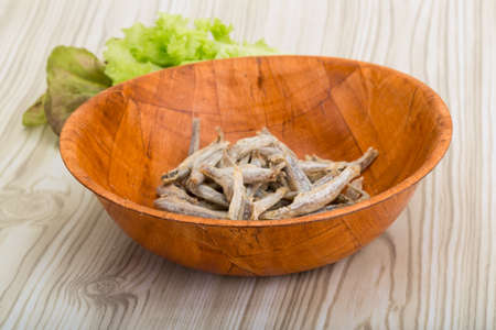 Dries anchovy - small fishes in the bowlの写真素材