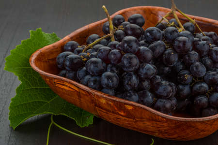 Red grape branch with leafの写真素材