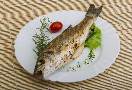 Grilled seabass fish - with rosemary and thymeの写真素材