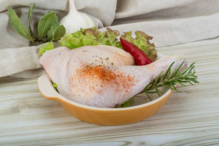 Chicken thigh with rosemary, pepper and salad leavesの写真素材