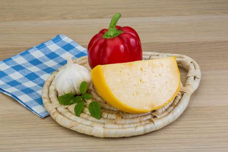Yellow round cheese on the wood backgroundの写真素材