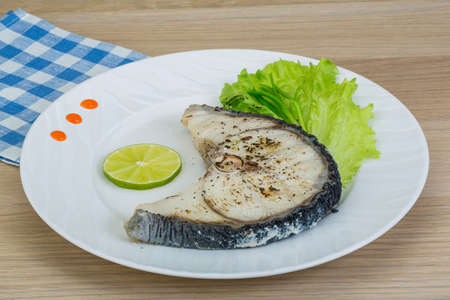 Grilled shark stesk with lime and salad leavesの写真素材