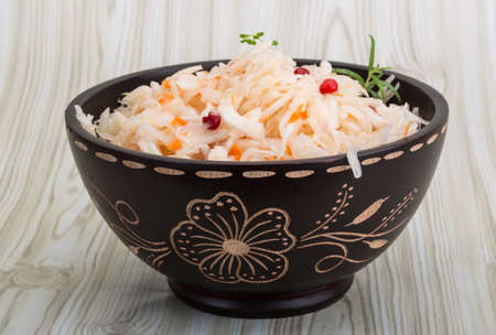 Sauerkraut with berries in the bowl on wooden backgroundの写真素材