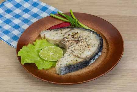 Grilled shark stesk with lime and salad leavesの写真素材