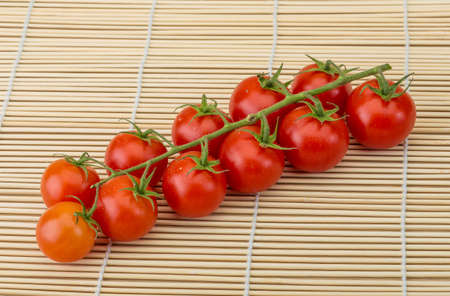 Fresh ripe Cherry tomatoes on the branchの写真素材