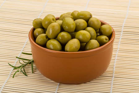 Green olives marinated - in the bowlの写真素材