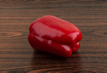 Fresh vivid Red bulgarian pepper on the wood backgroundの写真素材