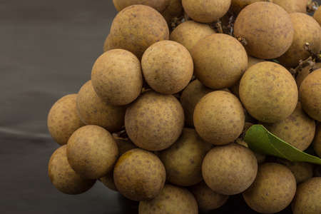 Asian fruit Longan - on wood backgroundの写真素材