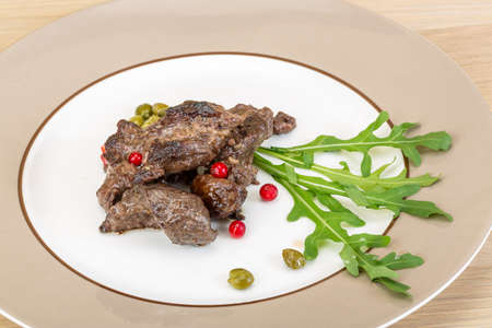 Roasted venison meat with ruccola and cranberriesの写真素材