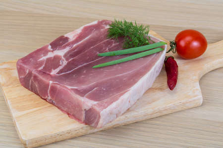 Raw pork meat ready for cooking with herbs