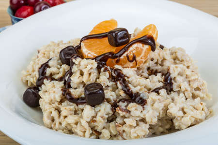 Oatmeal with fresh berries in the bowlの写真素材