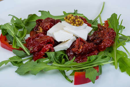 Salad with dried tomato and soft cheeseの写真素材