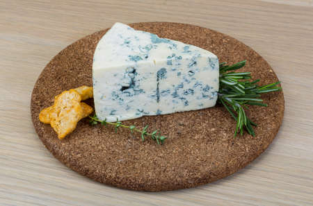 Blue cheese with mold on the wood backgroundの写真素材